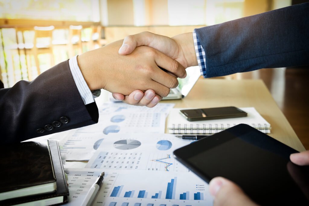 Featured case studies businessmen shaking hands during a meeting
